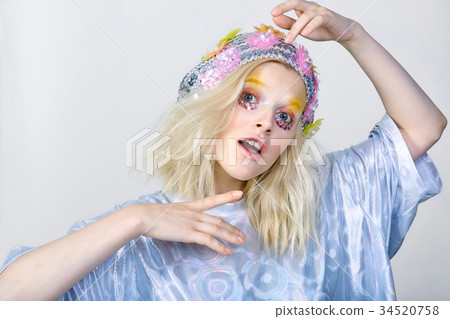 Young girl with colorfull makeup in sparkling hat 34520758