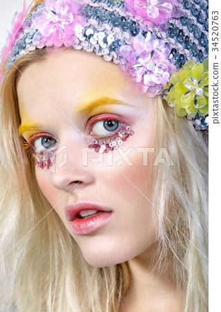 Young girl with colorfull makeup in sparkling hat 34520763