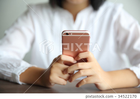 Asian young woman use smart phone portrait in coffee shop cafe Asian young woman use smart phone portrait in coffee shop cafe 34522170
