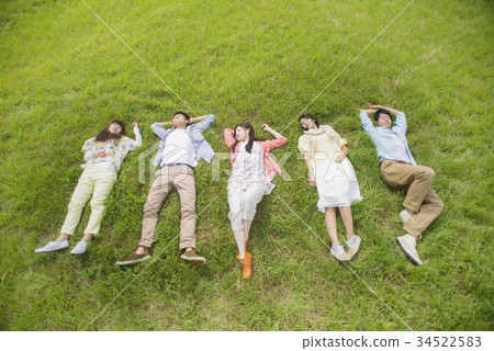 University student lying on the meadow 34522583