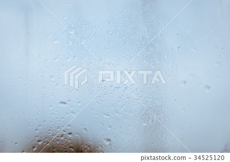 Raindrop Falling On The Window Glass In Blurry Bac 34525120