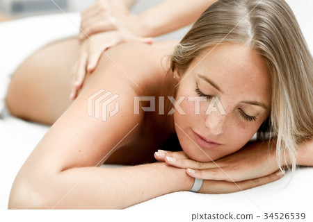 Young blonde woman having massage in the spa salon 34526539