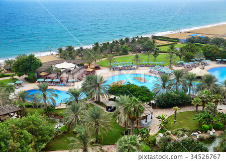The beach and swimming pools at luxury hotel 34526767