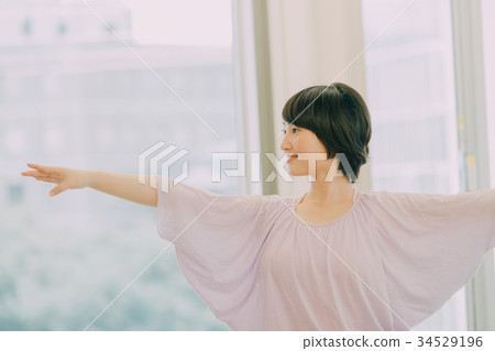 Young woman doing yoga in yoga studio Young woman doing yoga in yoga studio 34529196
