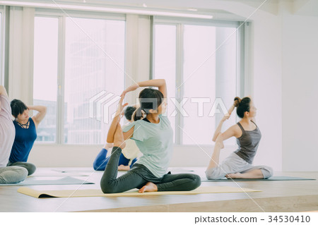Young woman doing yoga in studio Young woman doing yoga in studio 34530410