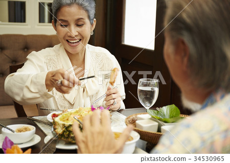 happy elder couple has a happy lunch in restaurant 34530965