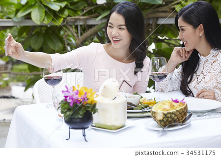 Two women are smiling very fresh and selfie in a restaurant Two women are smiling very fresh and selfie in a restaurant 34531175