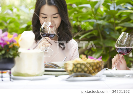 an elegant woman is enjoying wine with friends together outdoors an elegant woman is enjoying wine with friends together outdoors 34531192