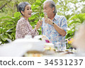 an old couple is having fun and enjoying wine together outdoors 34531237
