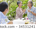 a nice older woman is talking and drinking wine with her husband in the banquet 34531241