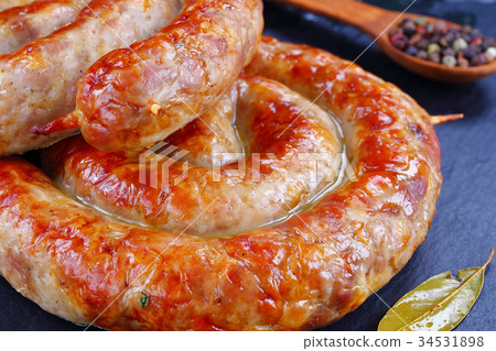 round fried spiral sausages on slate 34531898