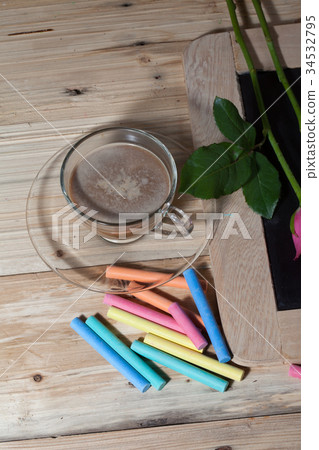 hot coffee on pinewood tabel with pastel 34532795