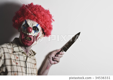 scary evil clown with a big knife 34536331