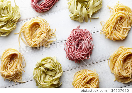 Several types of italian pasta on white wooden background Several types of italian pasta on white wooden background 34537620