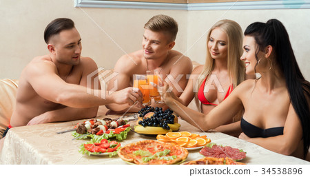 Two young couples at table with fruit and shashlik 34538896