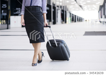 Business woman walking with wheeled bag 34541639