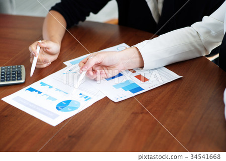 Business people pointing at diagrams Business people pointing at diagrams 34541668