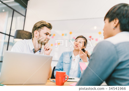 Multi-ethnic coworkers in team meeting at office Multi-ethnic coworkers in team meeting at office 34541966