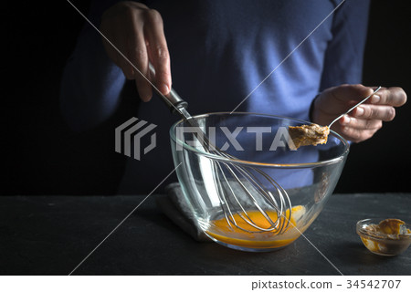 Whipped yolks, spoon in hand with mustard   34542707