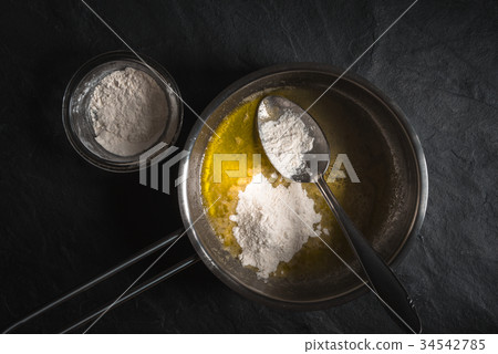 Flour in melted butter for roux cooking Flour in melted butter for roux cooking 34542785