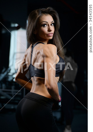Sexy athletic young girl training back in gym Sexy athletic young girl training back in gym 34543595