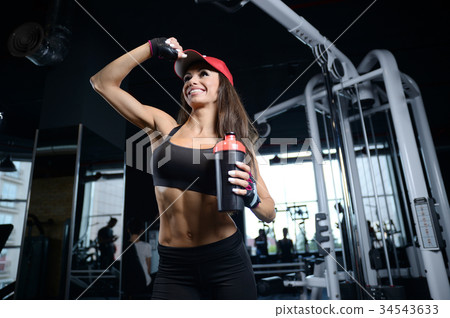 Sexy athletic young girl working out in gym Sexy athletic young girl working out in gym 34543633