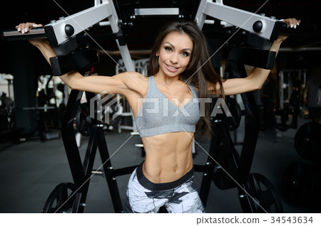 Sexy athletic young girl working out in gym Sexy athletic young girl working out in gym 34543634