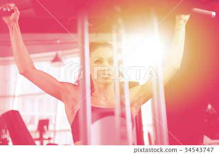 Sexy athletic young girl training back in gym Sexy athletic young girl training back in gym 34543747