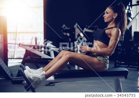 Sexy athletic young girl training back in gym Sexy athletic young girl training back in gym 34543755