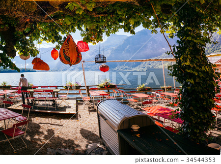 Summer cafe on the shore of a mountain lake Summer cafe on the shore of a mountain lake 34544353
