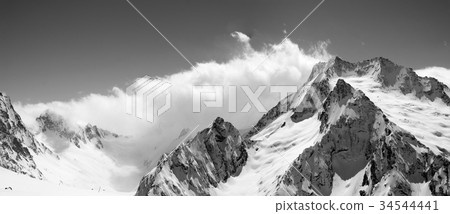 Black and white panoramic view on snow mountains 34544441