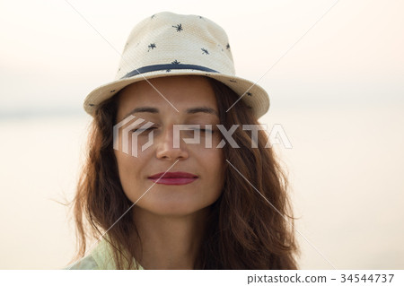Portrait of smiling woman with eyes closed  34544737