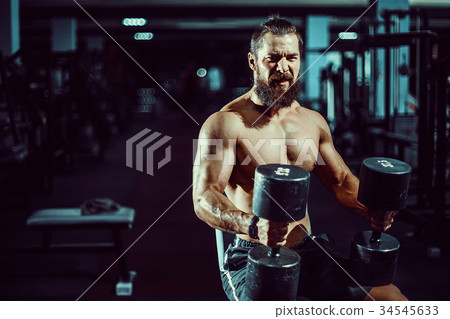 Strong man with big muscles, posing at the camera 34545633