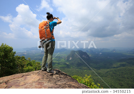 woman hiker enjoy the view hiking on mountain peak 34550215