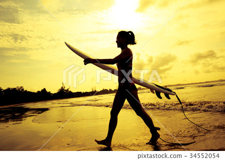 Young woman surfer with surfboard ready to surf 34552054