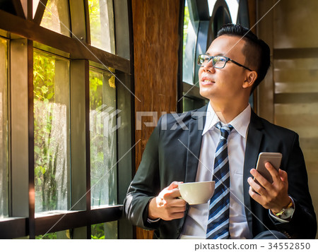 Portrait of businessman looking out of the window. Portrait of businessman looking out of the window. 34552850