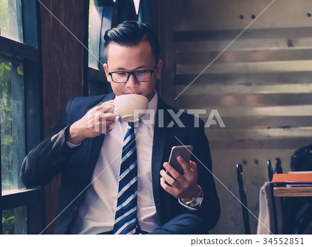 Portrait of businessman drinking a cup of coffee 34552851