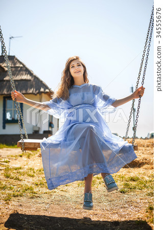 cute girl sitting on swing cute girl sitting on swing 34555676