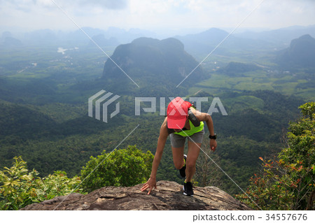 fitness woman trail runner running at mountain top 34557676