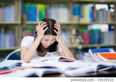 Asian lady student read a book before examination Asian lady student read a book before examination 34559518