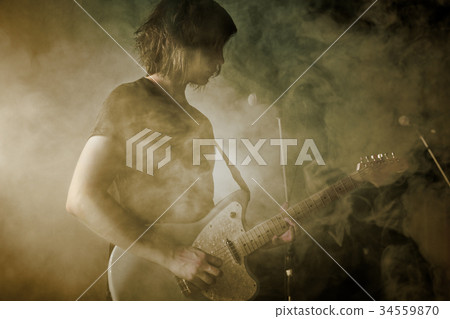 Guitarist plays solo. 34559870