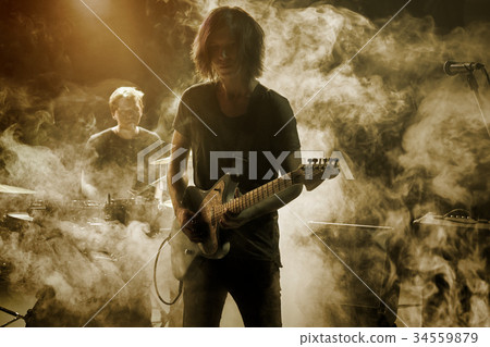 Guitarist plays solo. 34559879
