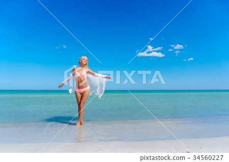Pretty blonde woman on the beach 34560227