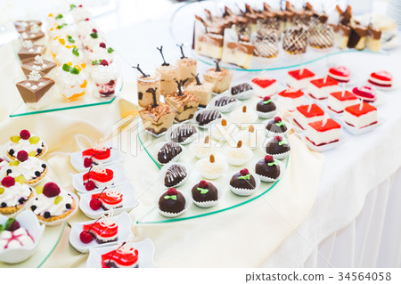 Delicious sweets on wedding candy buffet with 34564058