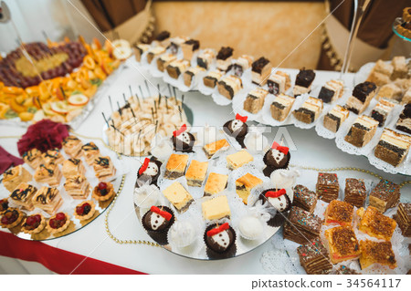 Different kinds of baked sweets on a buffet Different kinds of baked sweets on a buffet 34564117