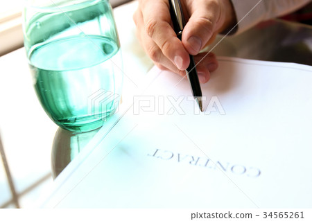 business man is signing a contract in the office 34565261