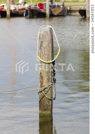 Nautical rope tied around a post Nautical rope tied around a post 34567853