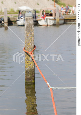 Nautical rope tied around a post Nautical rope tied around a post 34567854