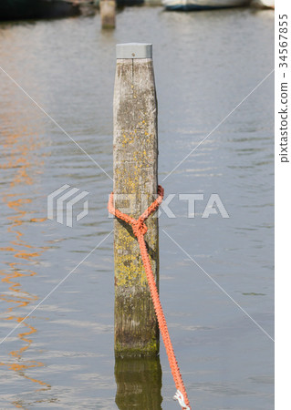 Nautical rope tied around a post Nautical rope tied around a post 34567855