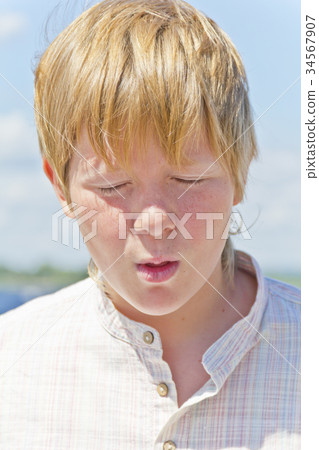 Portrait of squint blond boy near river Portrait of squint blond boy near river 34567907